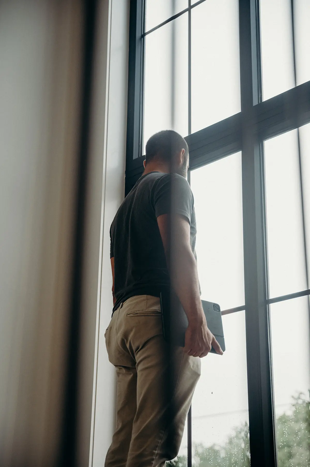 Rick Leitao of Woodfield Design + Build standing by a window during a custom home project