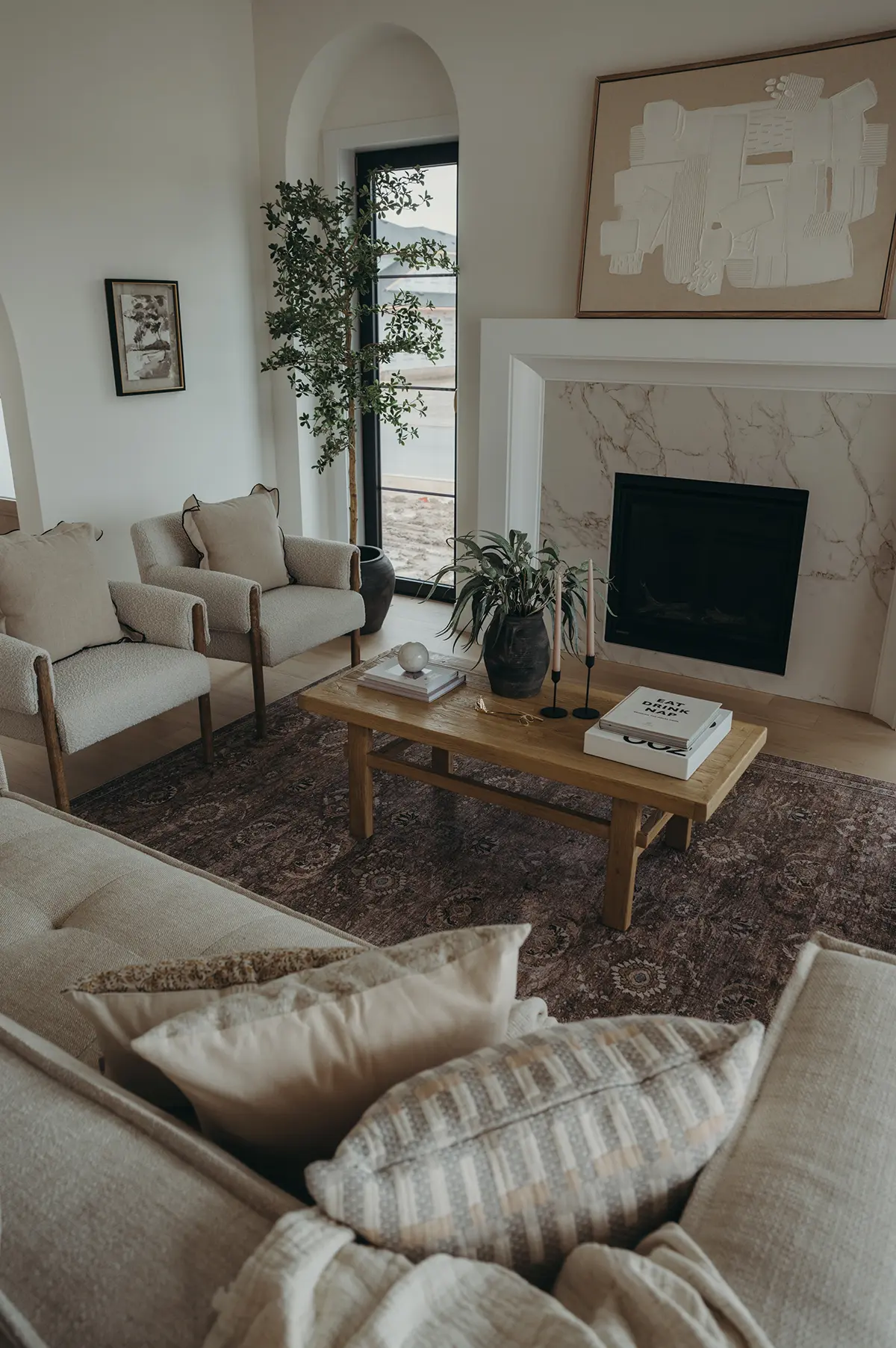 Custom-built living room in Harvest Run Community by Woodfield Design + Build showcasing modern fireplace and open-concept design