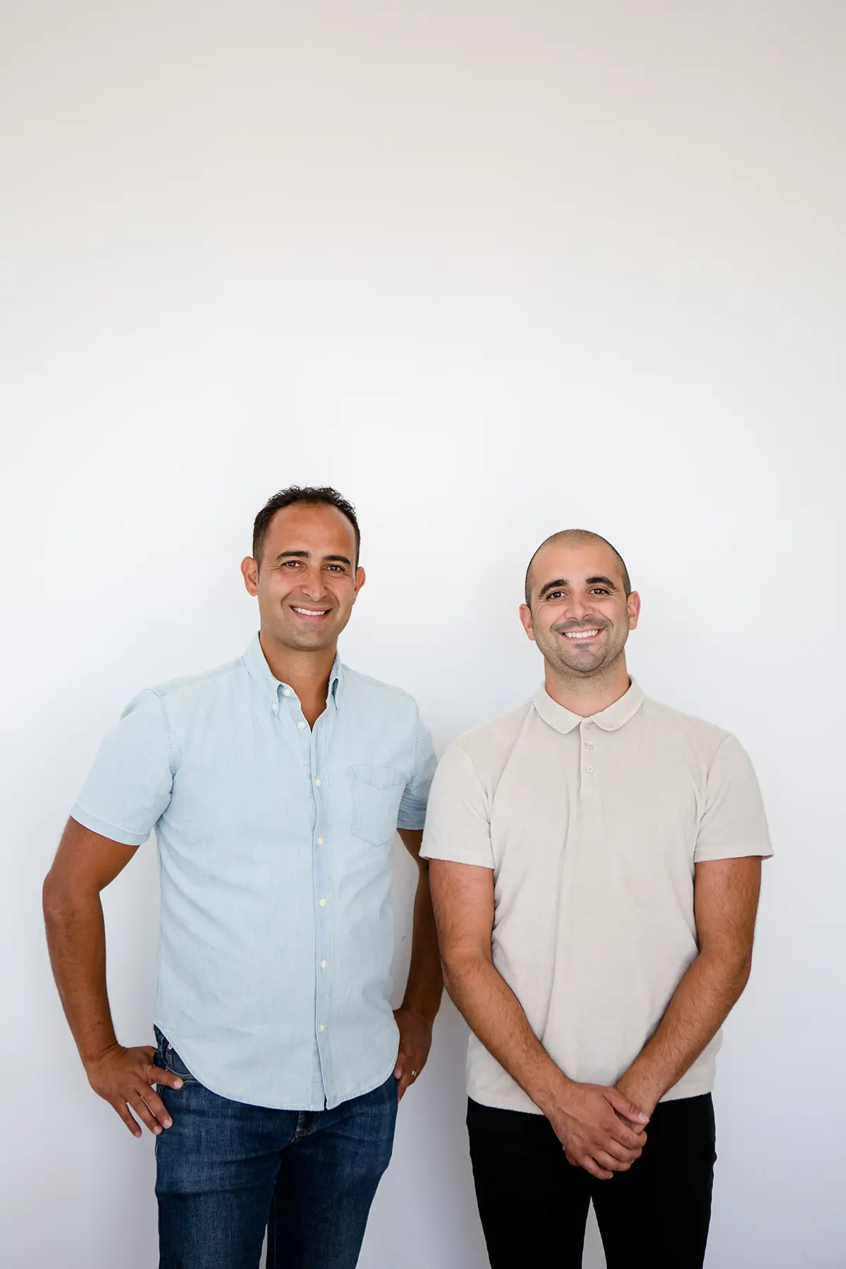 Rick Leitao and Phil Alves, founders of Woodfield Design + Build, standing together in studio portrait